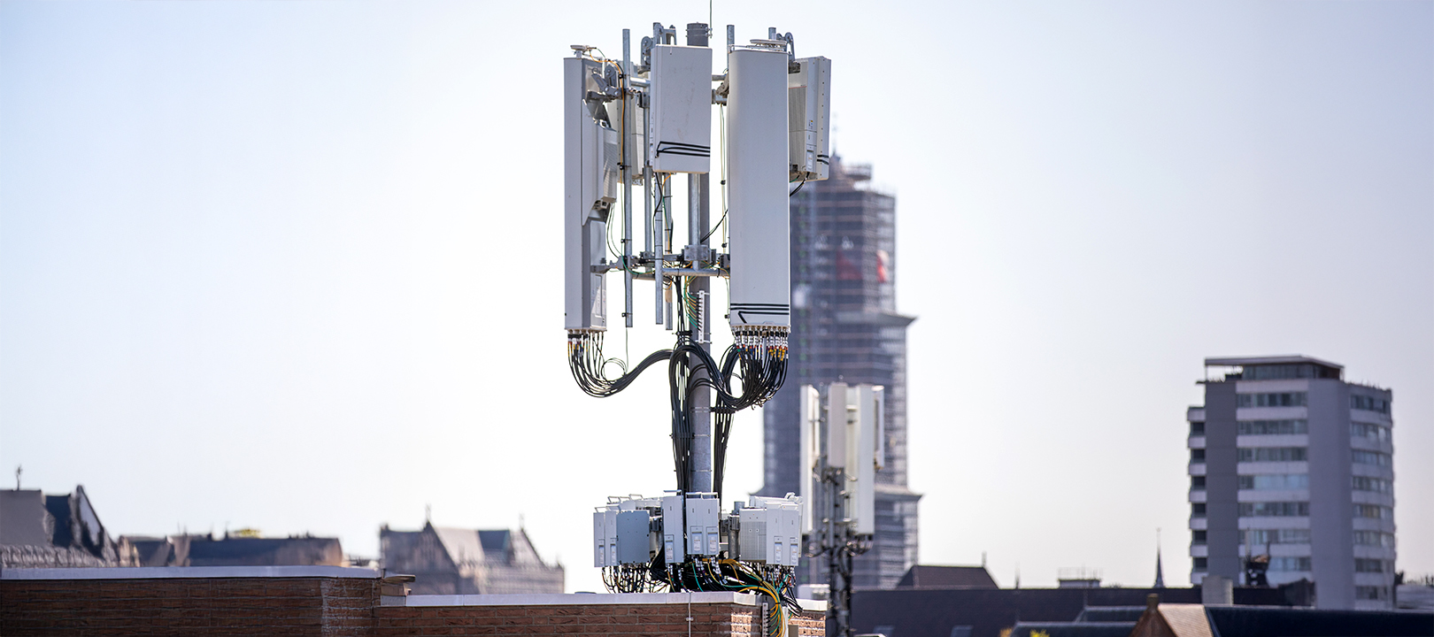 5g mobile tower installation with a clear sky in the background