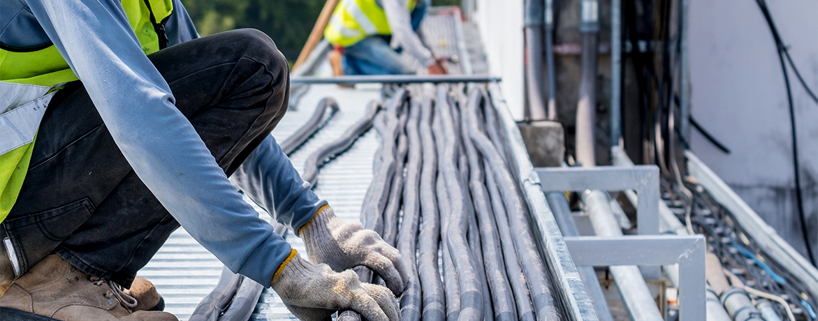 Workers are moving cables in construction sites.